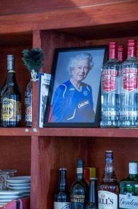 Queen Elizabeth's Portrait on the shelf of a bar in a Protesant Bar, Belfast, Northern Ireland